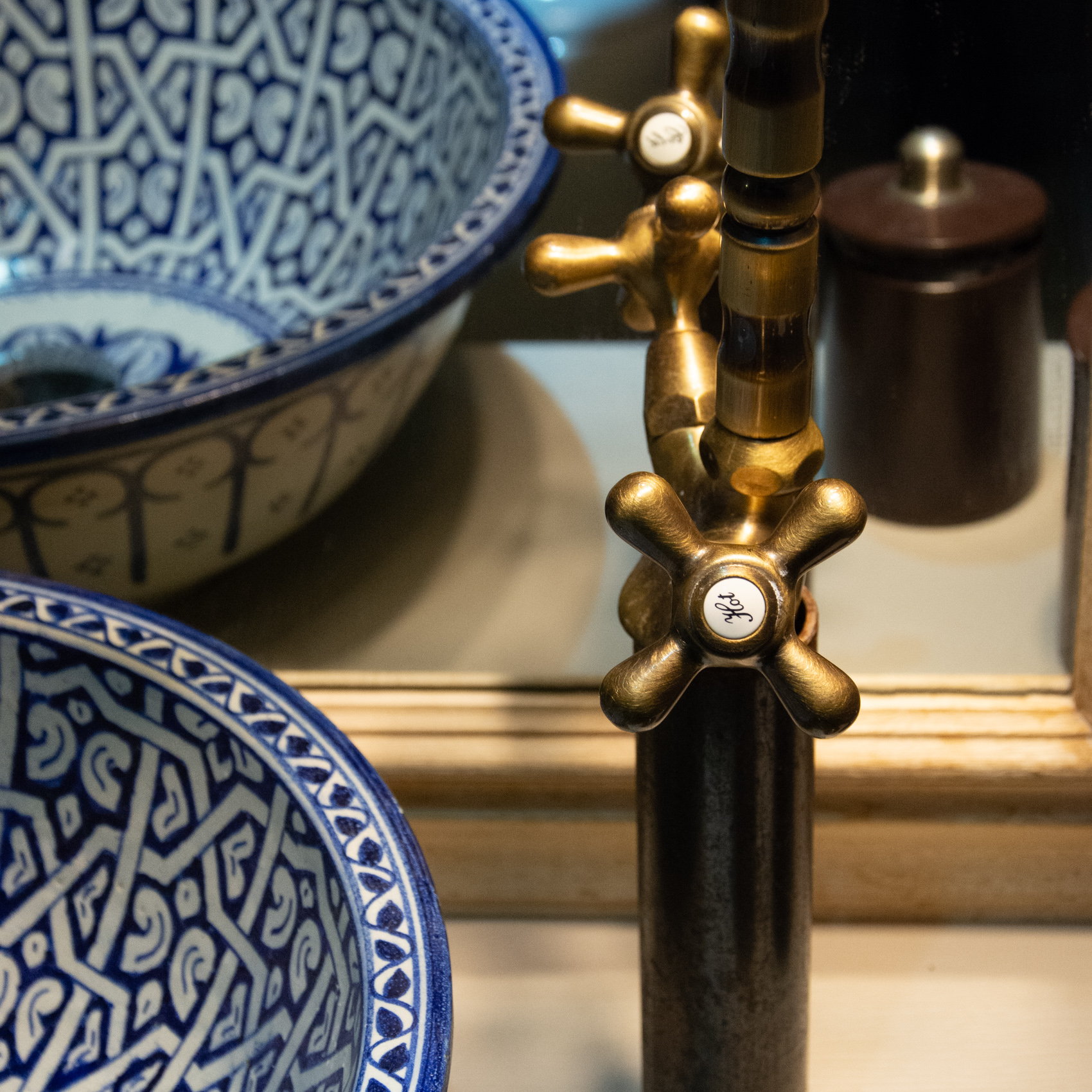 Detail of brass tap and hand-painted blue Moroccan basins