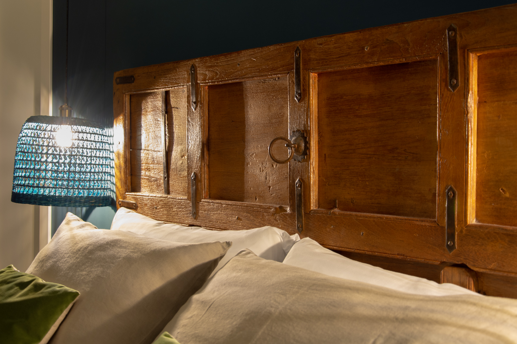 Close-up of the antique carved headboard and bedding