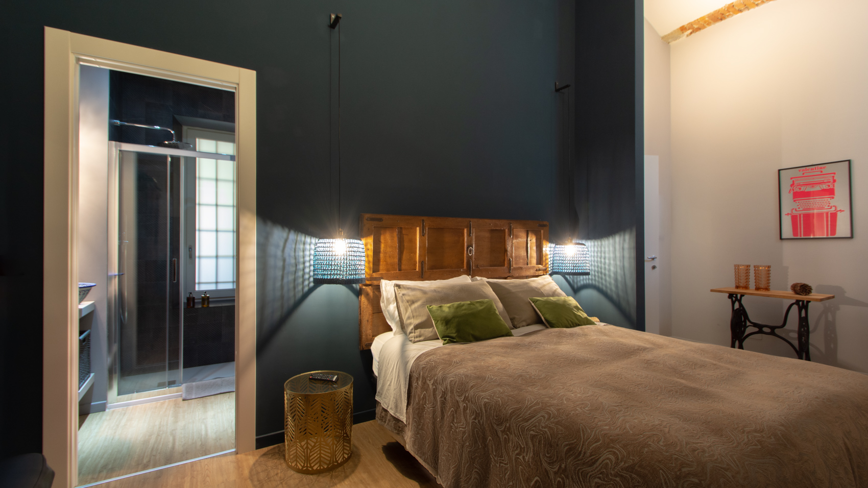 Bedroom two with full-length mirror and red framed artwork