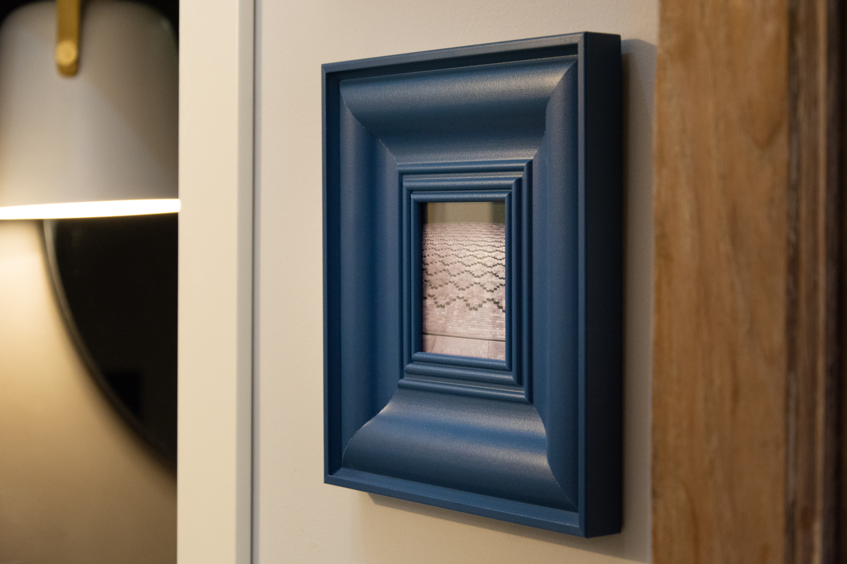 Deep Farrow & Ball blue carved frame, a signature colour of the flat