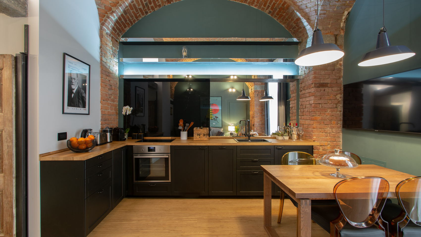 Open-plan kitchen and dining area with brick columns